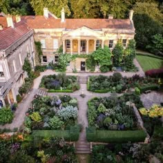 an aerial view of a large house surrounded by trees and bushes with lots of greenery