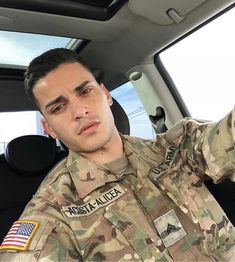 a soldier sitting in the back seat of a car