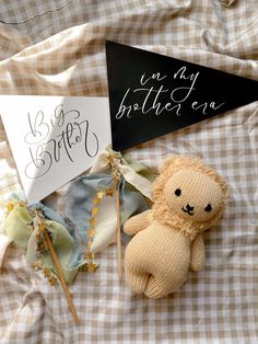 a teddy bear and sign on a bed