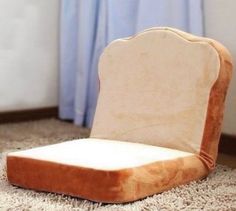 an upholstered chair sitting on the floor in front of a window