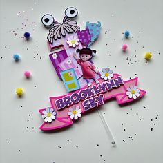 a birthday cake topper with the number one for brooklyn sky on it and flowers