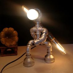 a light that is sitting on top of a table next to a lamp and some other items