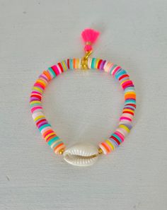 This beautiful, summery bracelet is handmade from 6 mm colorful Heishi beads. I have High-quality golden metal elements are used. A tassel makes the summer look perfect. The bracelet is strung on an elastic band and fits wrists with a circumference of approx. 15-17.5 cm. If you want to enjoy your bracelet for a long time, you should keep it away from perfume, sweat, water and too much sun. Handmade Rainbow Heishi Beads Stretch Bracelet, Hand-strung Heishi Bead Jewelry For Summer, Bohemian Multicolor Heishi Beads, Festival Multi-strand Heishi Beads Bracelets, Handmade Rainbow Heishi Beads, Heishi Beads, Elastic Band, Colorful Bracelets, Pearl Bracelet