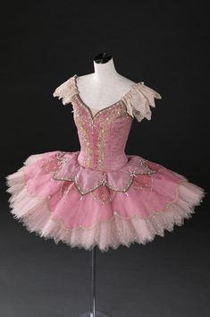 a pink and gold ballerina dress on a mannequin