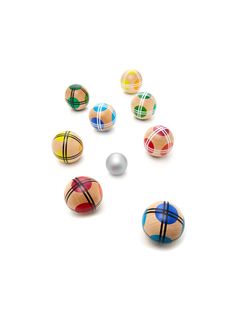 several wooden balls with different patterns and colors are arranged in the shape of a circle