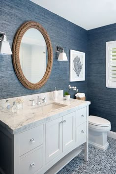 a bathroom with blue walls and white fixtures