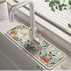 a kitchen sink with a floral design on it