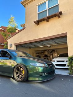 a green car parked in front of a house