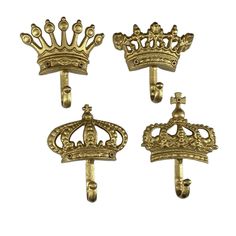 three gold colored metal wall hooks with crowns on them