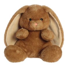 a brown stuffed rabbit sitting in front of a white background