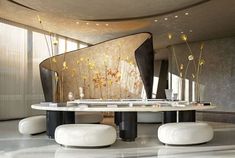 an artistically designed dining room with marble tables and stools