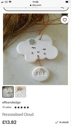 a white cloud ornament hanging from a string with the word love on it