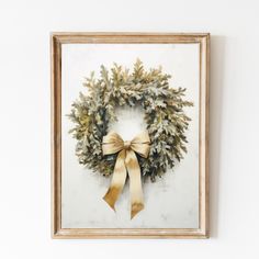 a painting of a wreath with a bow hanging on the wall next to a white wall