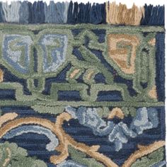 a blue and green rug with various designs on it