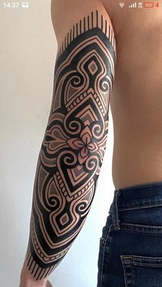 a man's arm with an intricate tattoo design on the left side of his body