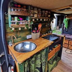 the inside of a camper with a sink and stove in it's center