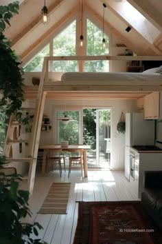 a loft bed is in the middle of a kitchen and dining area with an open floor plan