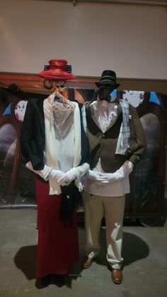 two mannequins dressed in costumes standing next to each other