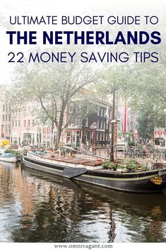 a boat floating on top of a river next to tall buildings with text overlay reading ultimate guide to the netherlands 22 money saving tips