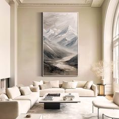 a living room filled with furniture and a painting on the wall