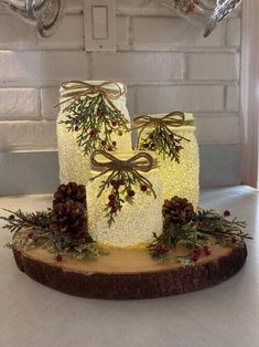 a lighted cake with pine cones and berries on it