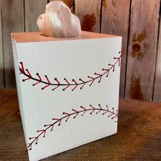 a tissue dispenser sitting on top of a wooden table