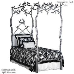 a bed with branches on the headboard and foot board, made out of metal