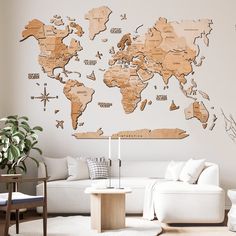 a living room filled with furniture and a large wooden world map wall decal on the wall