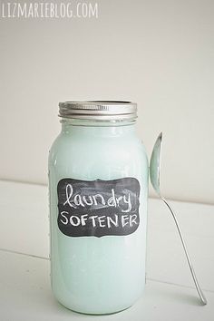 a jar with a spoon in it that says laundry softener