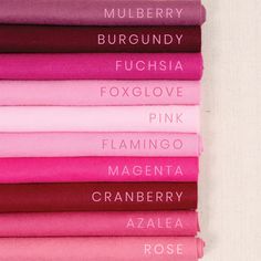 pink and purple sheets are stacked on top of each other, with the word fuchsia written across them