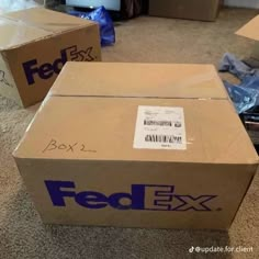 two fed ex boxes sitting on the floor