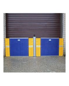 two blue and yellow storage units in front of a garage door