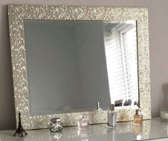 a bathroom vanity with a large mirror above it