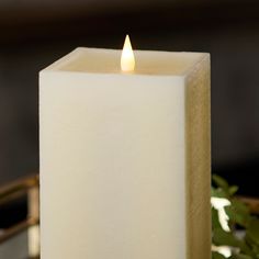 a white candle sitting on top of a table