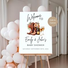 a welcome sign for a baby shower with boots and wine glasses on it in front of balloons