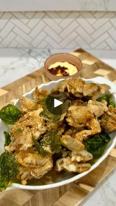 a white bowl filled with food on top of a wooden cutting board