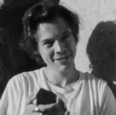 a black and white photo of a woman holding a piece of cake in her hands