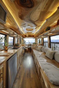 the interior of a bus with wood flooring and white couches on it's sides