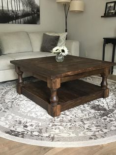 a living room with a couch, coffee table and rug