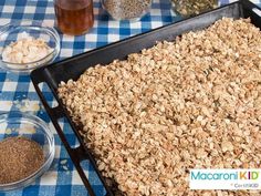 a table topped with lots of granola next to bowls of oatmeal