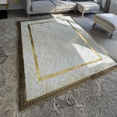 a living room filled with furniture and a large rug on top of carpeted floor