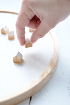 someone is playing with wooden blocks on the table