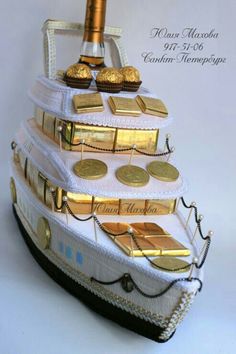 a white and gold decorated ship with coins on it's bottom, in front of a white background