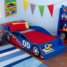 a child's bedroom with race car bedding and toys