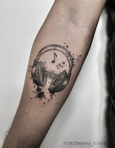 a tattoo with headphones and music notes on it