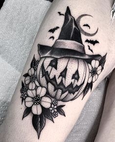 a black and white image of a pumpkin with a witches hat on it