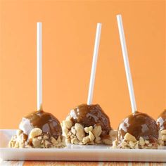 chocolate covered marshmallows are sitting on a plate with toothpicks in them