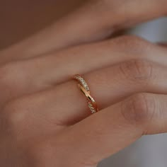 a woman's hand with a diamond ring on it