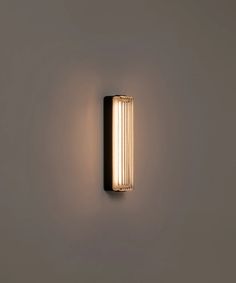 a wall light that is on the side of a wall with no lighting in it