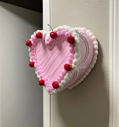 a heart shaped cake hanging on the wall